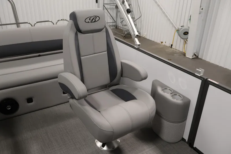 Slide: The Image of 2026 Bentley Pontoons 220 SWINGBACK captain's chair with cup holders in a sleek interior. - 26
