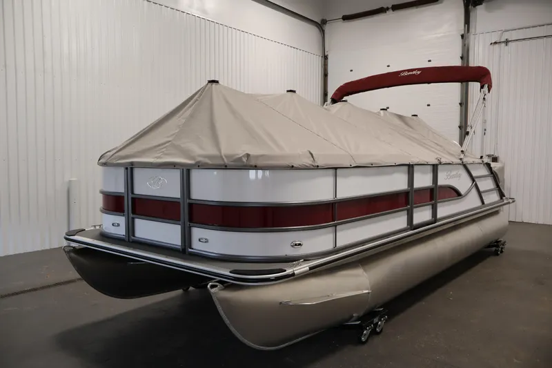 Slide: The Image of 2026 Bentley Pontoons 220 SWINGBACK with cover in a garage setting. - 32