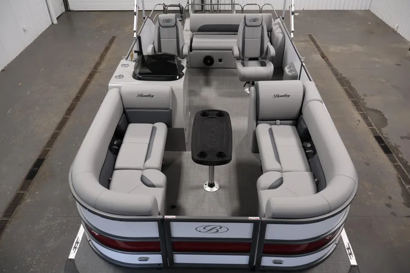 Slide: The Image of 2026 Bentley Pontoons 220 SWINGBACK with luxurious seating and sleek design in a showroom. - 8