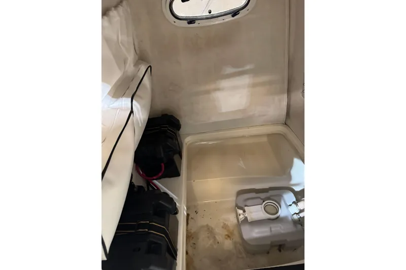 Slide: The Image of Interior of a 2000 Boston Whaler 21 Outrage boat, featuring storage and equipment. - 11