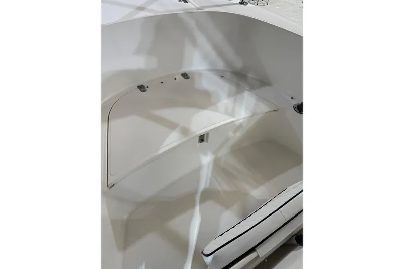 Slide: The Image of Interior view of a 2000 Boston Whaler 21 Outrage boat, featuring seating and storage. - 14