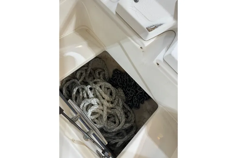 Slide: The Image of Storage compartment with ropes and chain on a 2000 Boston Whaler 21 Outrage boat. - 15