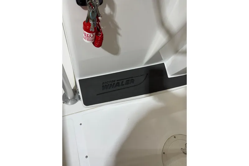 Slide: The Image of Boston Whaler 21 Outrage 2000 boat interior with logo and safety equipment. - 16