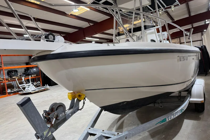 Slide: The Image of 2000 Boston Whaler 21 Outrage boat on trailer in indoor storage facility. - 19