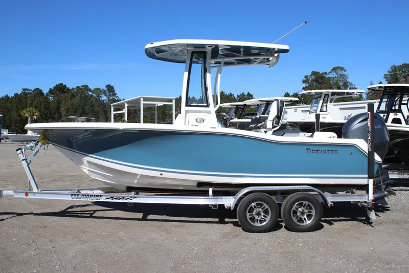 The Image of 2026 Tidewater 210 LXF boat on trailer, blue hull, parked outdoors. - 1
