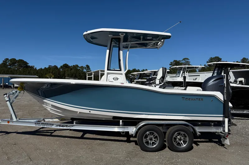 Slide: The Image of 2026 Tidewater 210 LXF boat on trailer, blue hull, parked outdoors. - 10