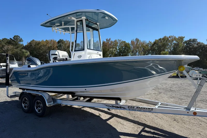 Slide: The Image of 2026 Tidewater 210 LXF boat on trailer, blue hull, parked outdoors. - 14