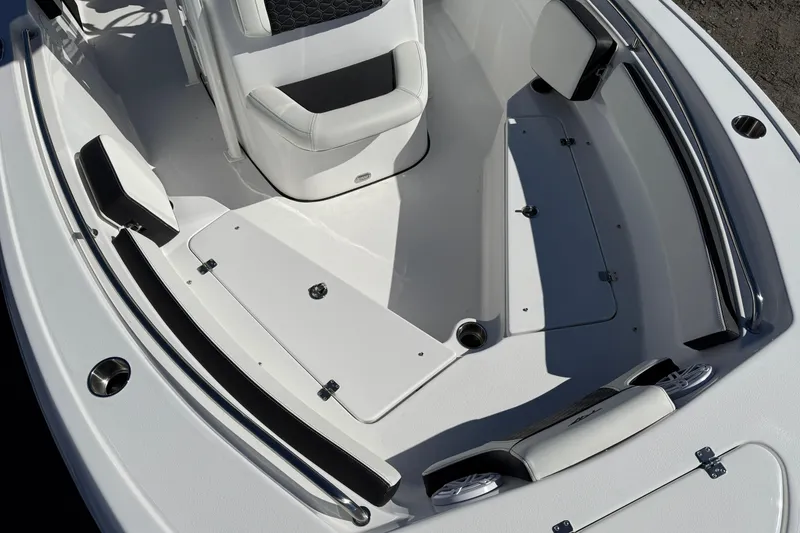 Slide: The Image of 2026 Tidewater 210 LXF boat interior with white seating and storage compartments. - 16