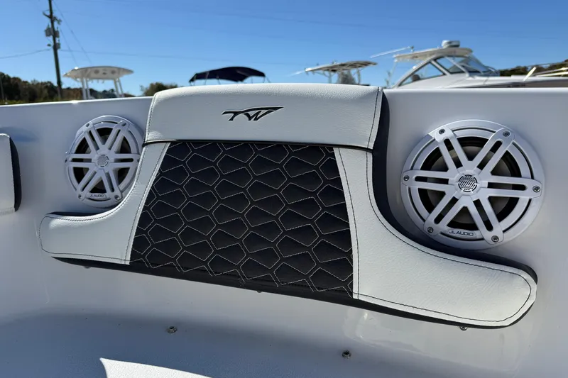 Slide: The Image of 2026 Tidewater 210 LXF boat interior with JL Audio speakers and stylish upholstery. - 19