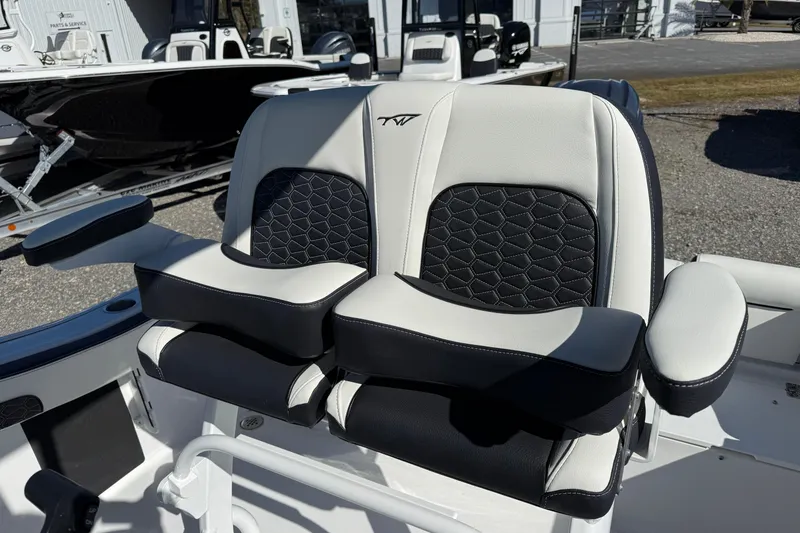 Slide: The Image of 2026 Tidewater 210 LXF boat seats with black and white upholstery, featuring armrests. - 20
