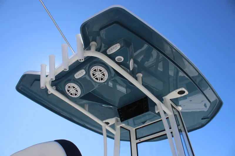 Slide: The Image of Tidewater 210 LXF 2026 boat top view with speakers and rod holders against blue sky. - 26