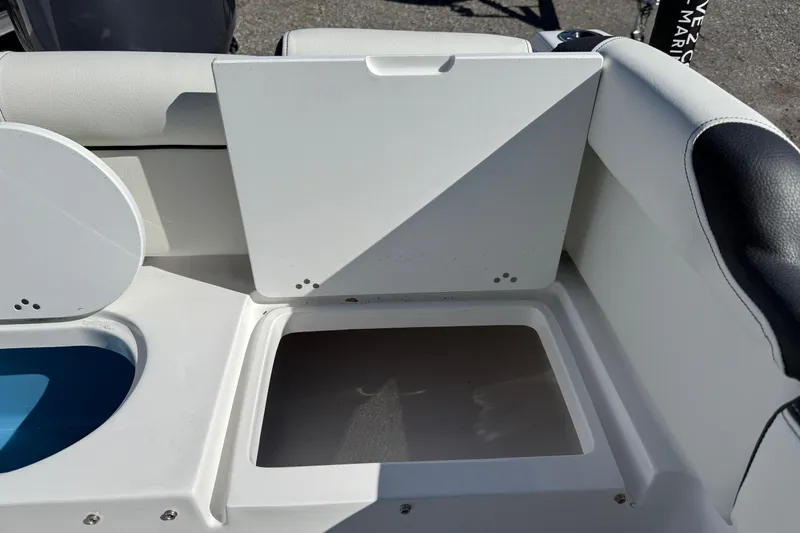 Slide: The Image of 2026 Tidewater 210 LXF boat storage compartment with open lid, showcasing interior space. - 4