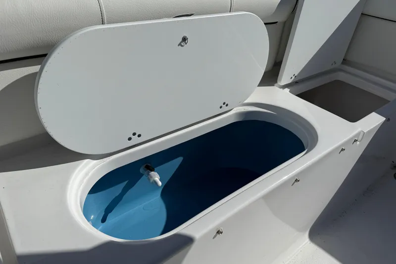 Slide: The Image of Livewell compartment on a 2026 Tidewater 210 LXF boat, featuring a blue interior. - 5