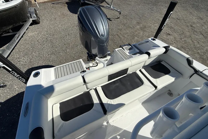 Slide: The Image of 2026 Tidewater 210 LXF boat interior with seating and outboard motor. - 6