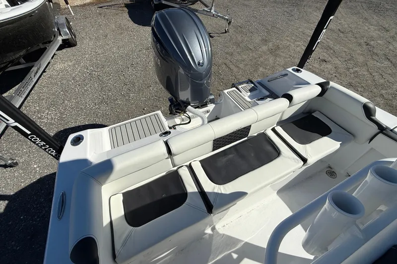 Slide: The Image of 2026 Tidewater 210 LXF boat interior with seating and outboard motor. - 8