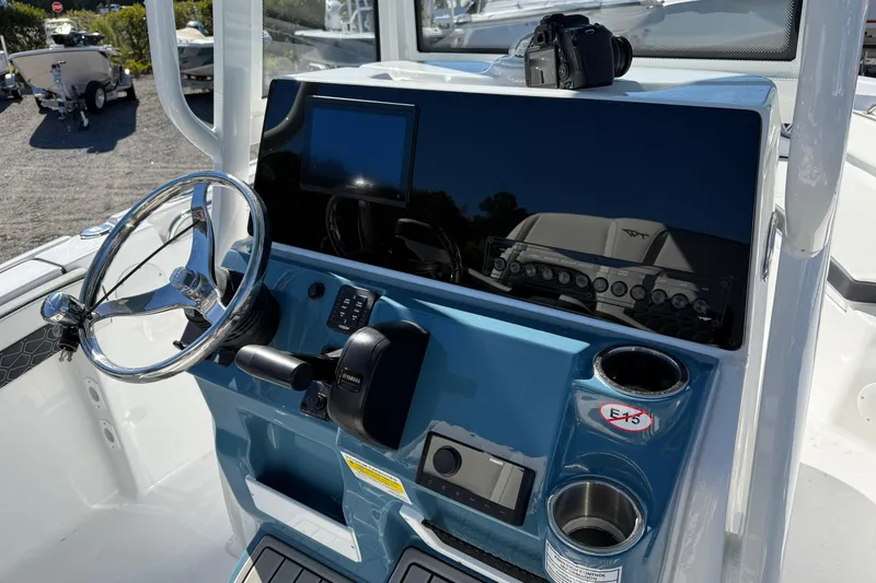 Slide: The Image of 2026 Tidewater 210 LXF boat dashboard with steering wheel and electronic controls. - 9