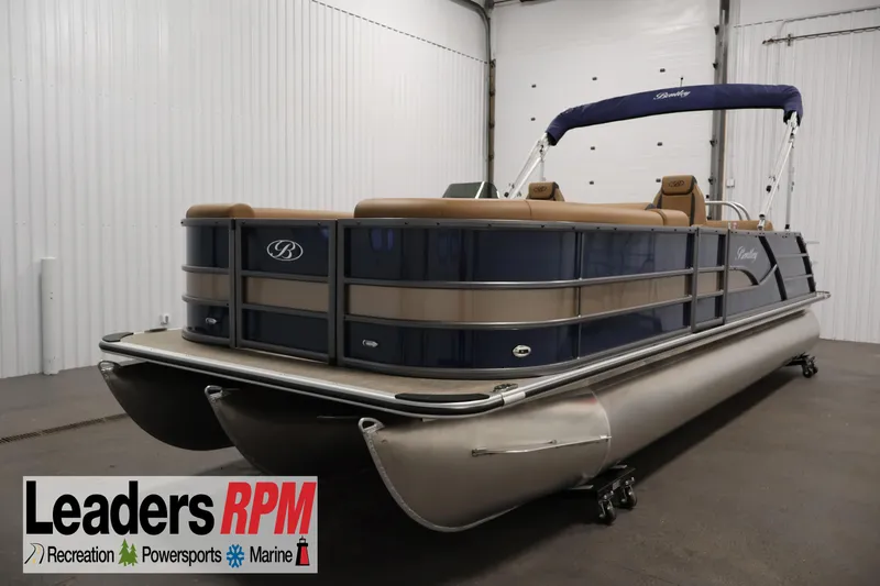 The Image of 2026 Bentley Pontoons 243 Swingback Tri-toon in showroom, featuring sleek design and luxury seating. - 0