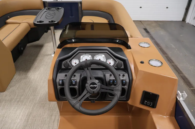 Slide: The Image of 2026 Bentley Pontoons 243 Swingback Tri-toon dashboard with steering wheel and seating area. - 17