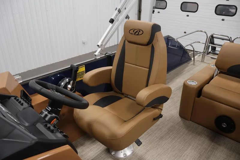 Slide: The Image of 2026 Bentley Pontoons 243 Swingback Tri-toon captain's chair and helm, luxurious tan interior. - 24