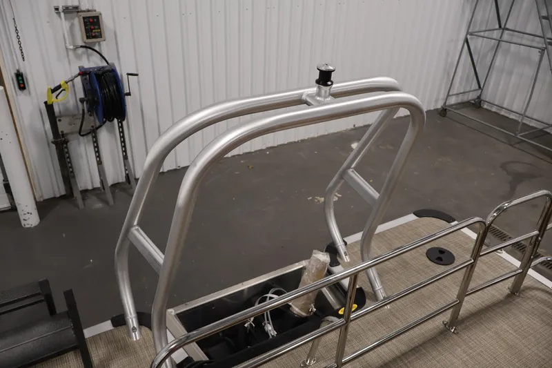 Slide: The Image of 2026 Bentley Pontoons 243 Swingback Tri-toon with sleek aluminum frame in a workshop. - 30