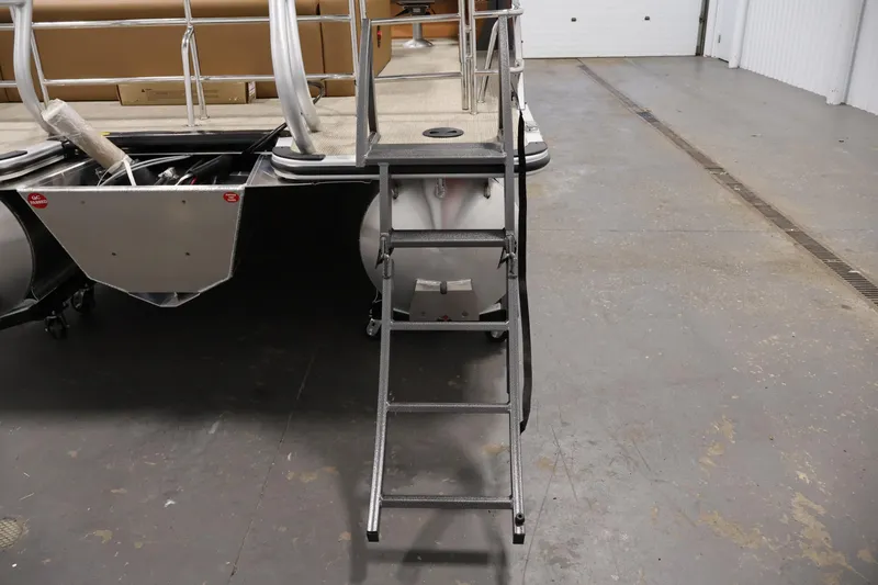 Slide: The Image of 2026 Bentley Pontoons 243 Swingback Tri-toon with ladder in a warehouse setting. - 31