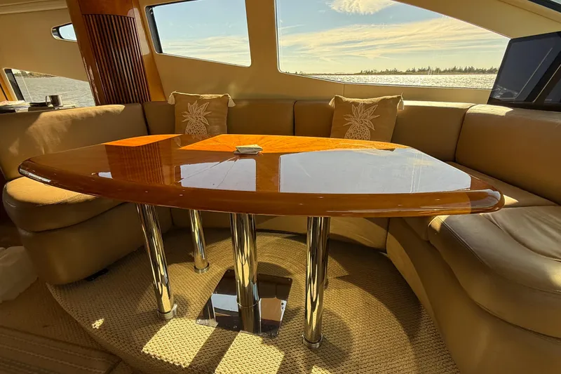 Slide: The Image of Luxurious interior of 2005 Sunseeker 75 Sport Yacht with elegant wooden table and plush seating. - 12