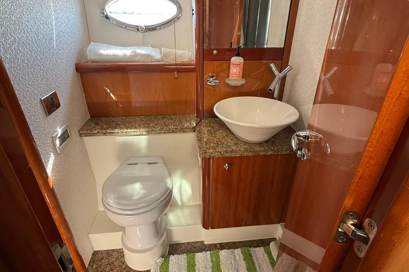 Slide: The Image of Luxurious bathroom in 2005 Sunseeker 75 Sport Yacht with modern fixtures and wood accents. - 25