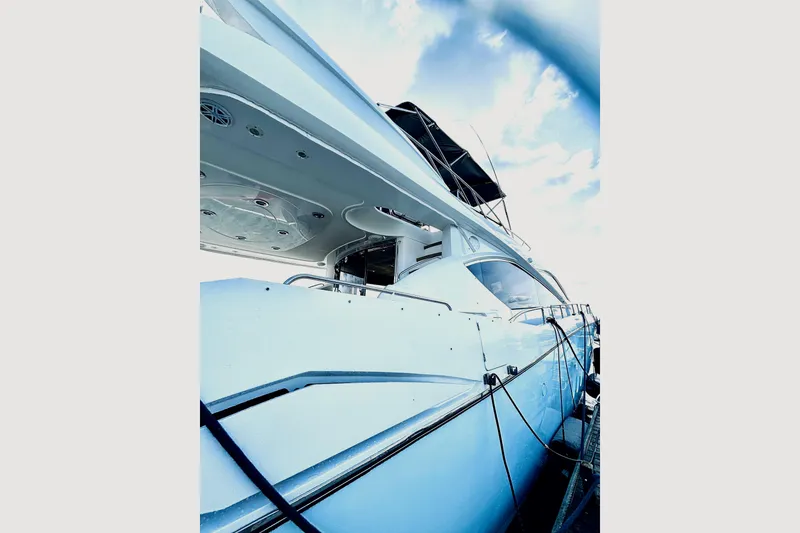 Slide: The Image of 2005 Sunseeker 75 Flybridge yacht docked under a cloudy sky. - 3
