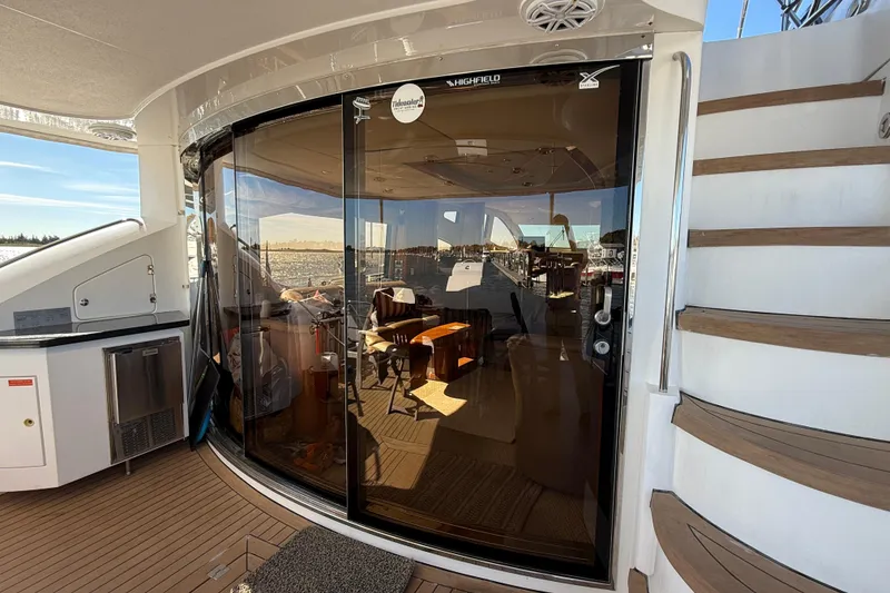 Slide: The Image of Luxurious 2005 Sunseeker 75 Sport Yacht interior with elegant wooden staircase and glass doors. - 4