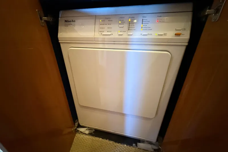 Slide: The Image of Miele dryer inside a 2005 Sunseeker 75 Sport Yacht, with control panel visible. - 40