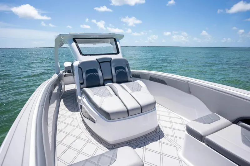 Slide: The Image of 2024 Deep Impact 369 Sport boat on open water, featuring sleek seating and modern design. - 12