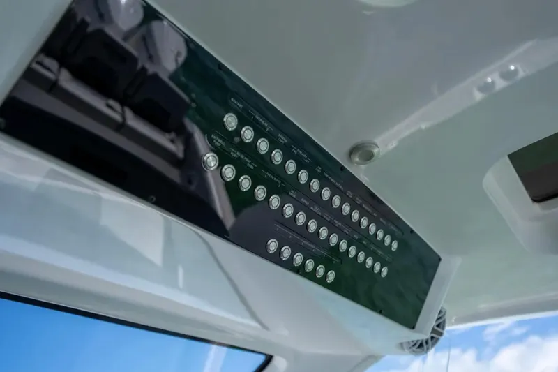 Slide: The Image of Control panel of 2024 Deep Impact 369 Sport boat, featuring multiple buttons and sleek design. - 13