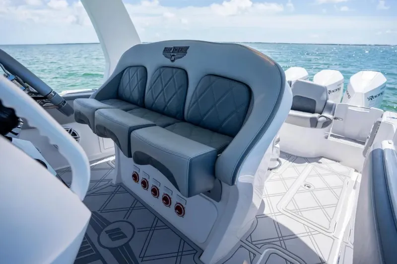 Slide: The Image of 2024 Deep Impact 369 Sport boat interior with luxurious seating and ocean view. - 14