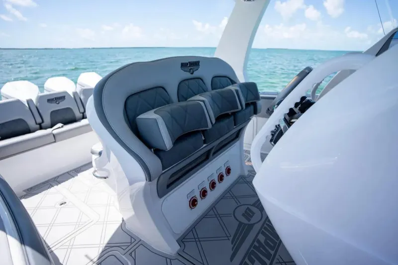 Slide: The Image of 2024 Deep Impact 369 Sport boat interior with luxurious seating and ocean view. - 16