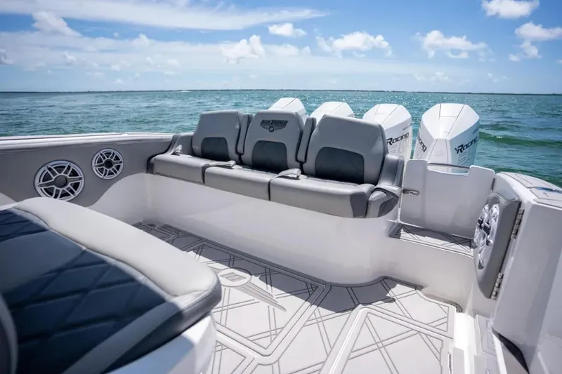 Slide: The Image of 2024 Deep Impact 369 Sport boat interior with seating and powerful outboard engines. - 19