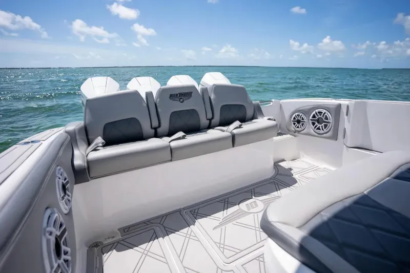 Slide: The Image of 2024 Deep Impact 369 Sport boat interior with cushioned seating and ocean view. - 20