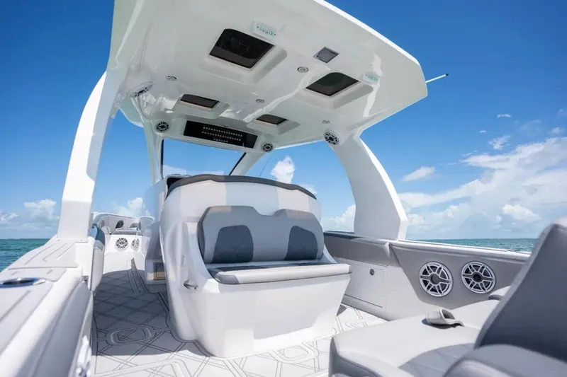 Slide: The Image of 2024 Deep Impact 369 Sport boat interior with modern seating and ocean view. - 21