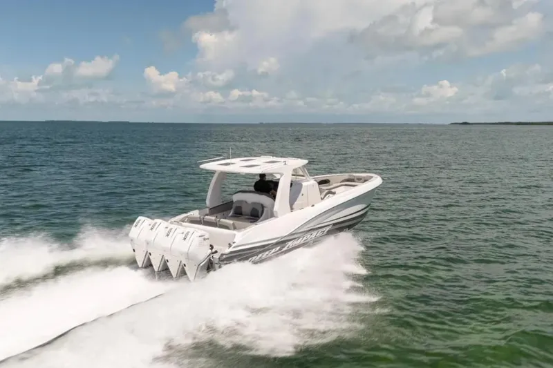 Slide: The Image of 2024 Deep Impact 369 Sport boat cruising on open water under a cloudy sky. - 23