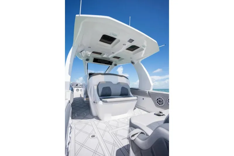 Slide: The Image of 2024 Deep Impact 369 Sport boat interior with modern seating and sleek design under a clear blue sky. - 27