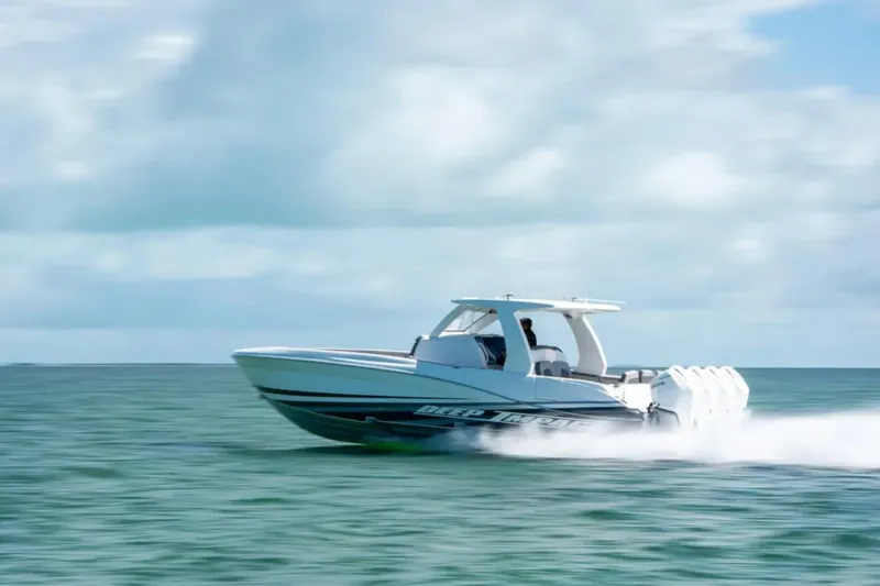 Slide: The Image of 2024 Deep Impact 369 Sport boat speeding on open water under a cloudy sky. - 34