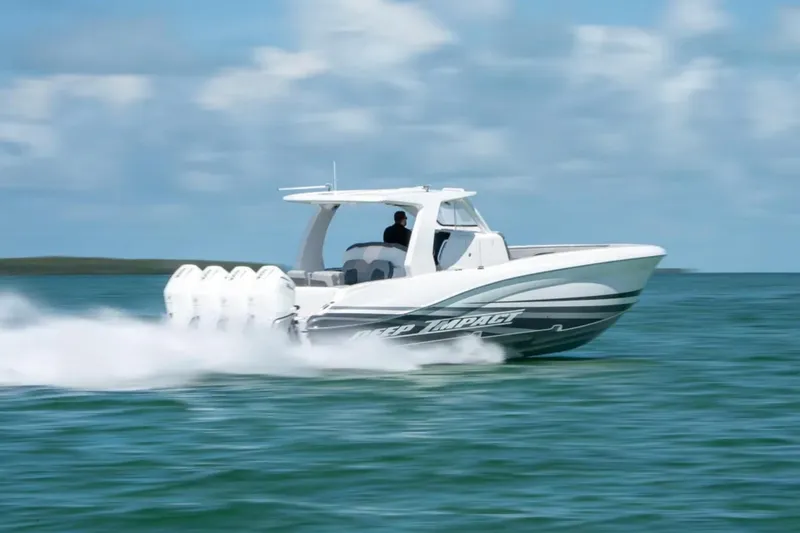 Slide: The Image of 2024 Deep Impact 369 Sport boat speeding on open water under a clear sky. - 36