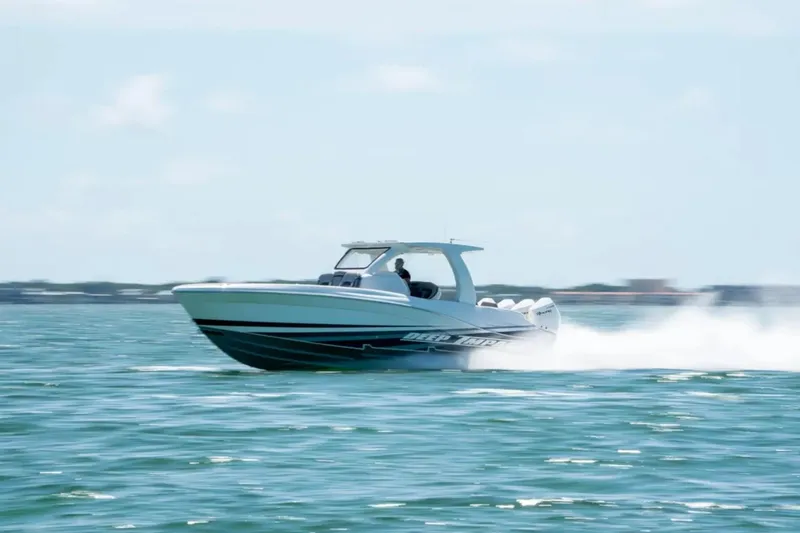 Slide: The Image of 2024 Deep Impact 369 Sport boat speeding on open water, showcasing sleek design and performance. - 39