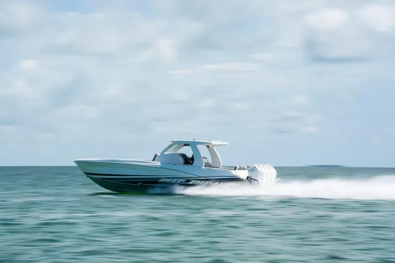 Slide: The Image of 2024 Deep Impact 369 Sport boat speeding on open water under a cloudy sky. - 41