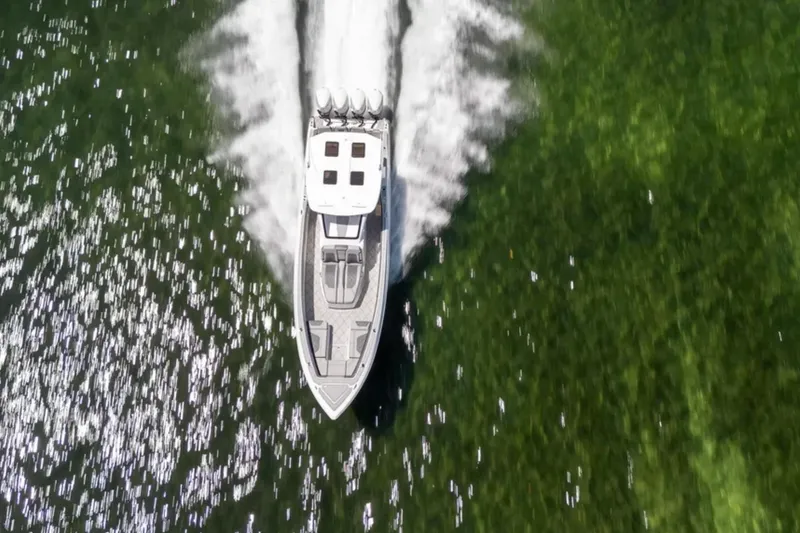 Slide: The Image of Aerial view of 2024 Deep Impact 369 Sport boat speeding on green water. - 42