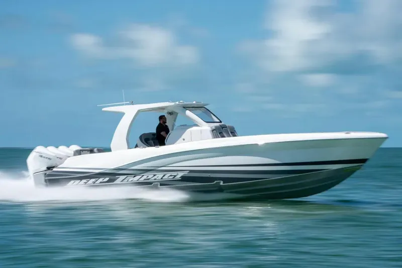 Slide: The Image of 2024 Deep Impact 369 Sport boat speeding on open water under clear skies. - 7