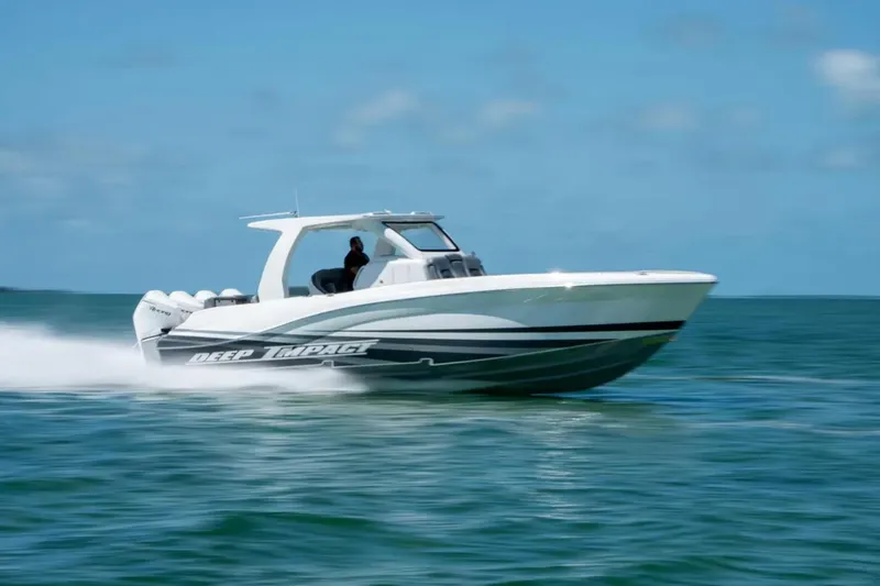 Slide: The Image of 2024 Deep Impact 369 Sport boat speeding on open water under clear blue sky. - 8