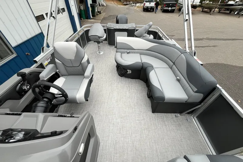Slide: The Image of 2025 Avalon LSZ Rear Fish boat interior with gray seating and steering console. - 11