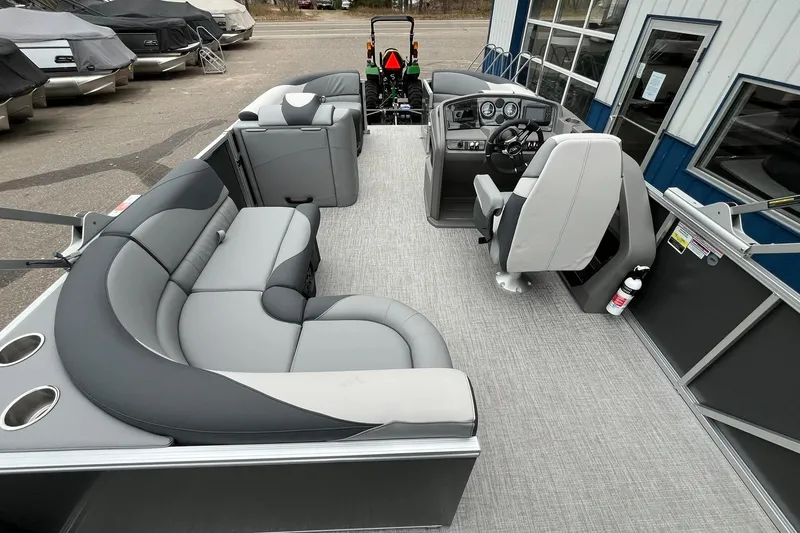 Slide: The Image of 2025 Avalon LSZ Rear Fish pontoon boat interior with gray seating and modern dashboard. - 15