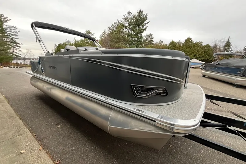 Slide: The Image of 2025 Avalon LSZ Rear Fish pontoon boat parked on a trailer. - 5
