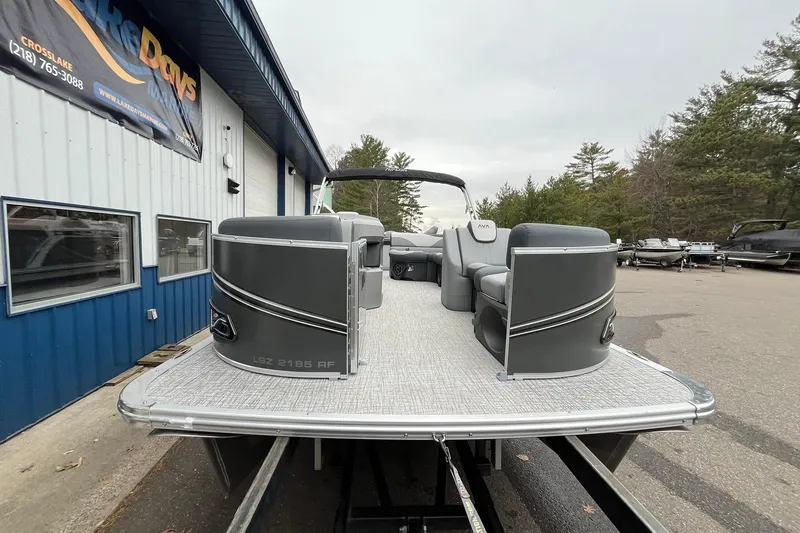 Slide: The Image of 2025 Avalon LSZ Rear Fish pontoon boat at dealership, showcasing sleek design and seating. - 6